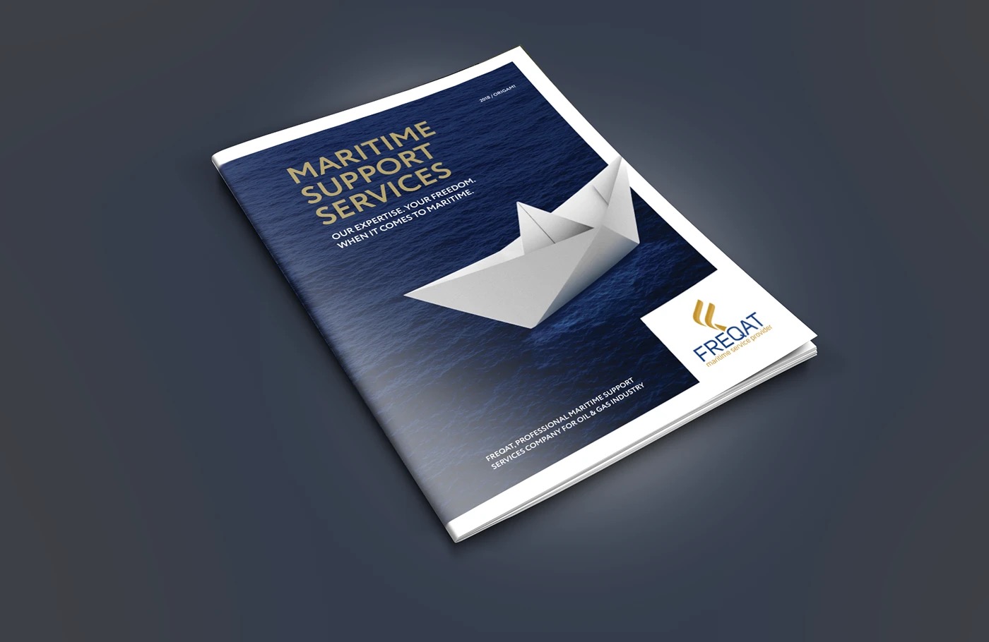 The printed magazine in a 3D mockup, cover showing the paper boat and Freqat logo