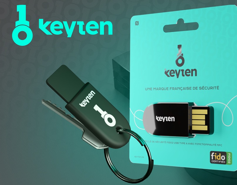 The keyten security key on its keyring next to the mint retail blister pack, FIDO certified